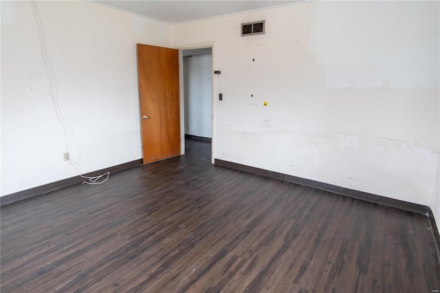 spare room featuring dark hardwood / wood-style floors