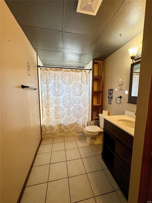 bathroom with tile patterned floors, vanity, and toilet