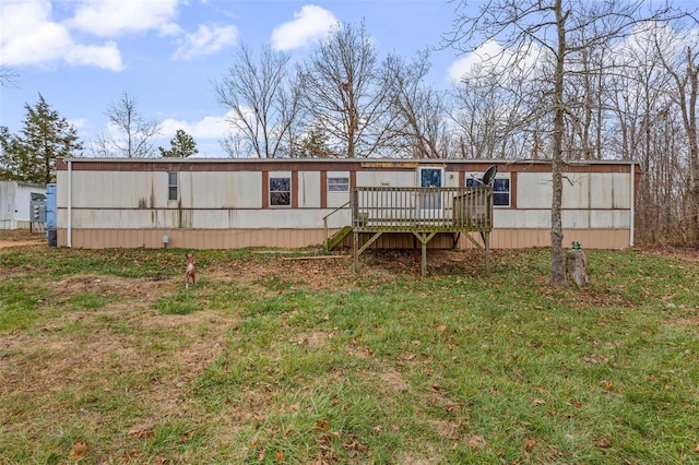 rear view of house with a deck and a lawn