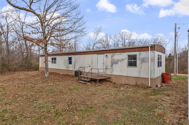 rear view of property featuring central air condition unit