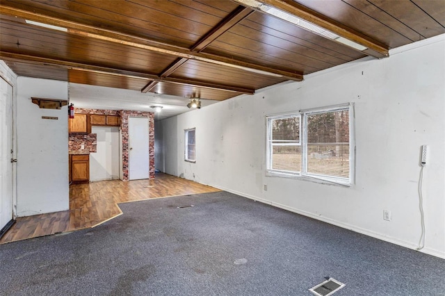 unfurnished living room with beamed ceiling, wood ceiling, and hardwood / wood-style flooring