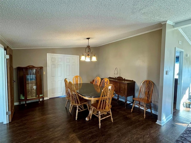 dining space with ornamental molding, dark wood-type flooring, a textured ceiling, and a notable chandelier