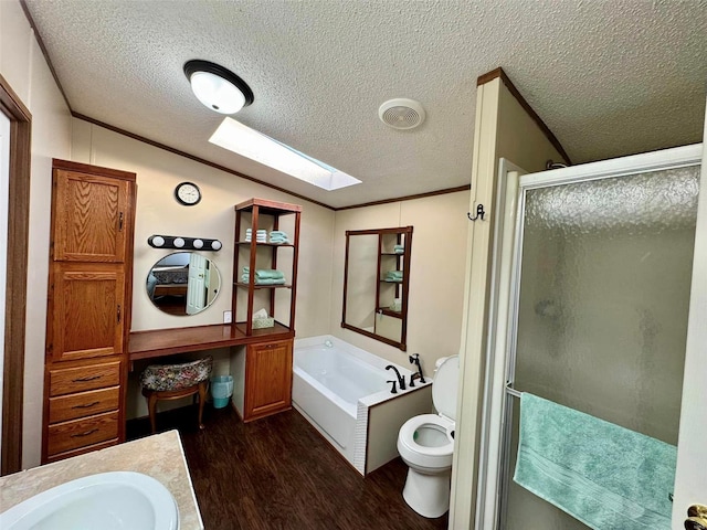 full bathroom featuring plus walk in shower, hardwood / wood-style floors, a textured ceiling, toilet, and vanity