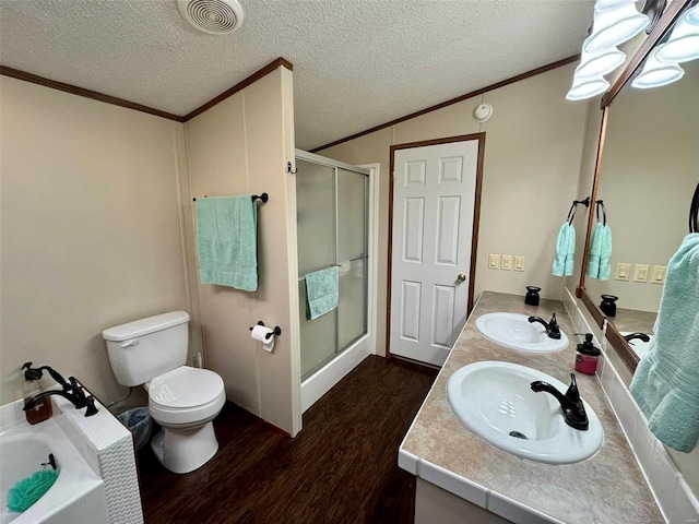 full bathroom featuring plus walk in shower, wood-type flooring, vanity, and a textured ceiling