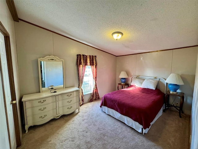 bedroom featuring a textured ceiling, carpet floors, and ornamental molding