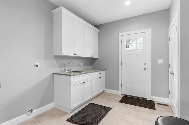 clothes washing area with hookup for an electric dryer and sink