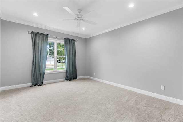 carpeted empty room with ceiling fan and ornamental molding