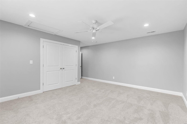 interior space featuring light carpet and ceiling fan