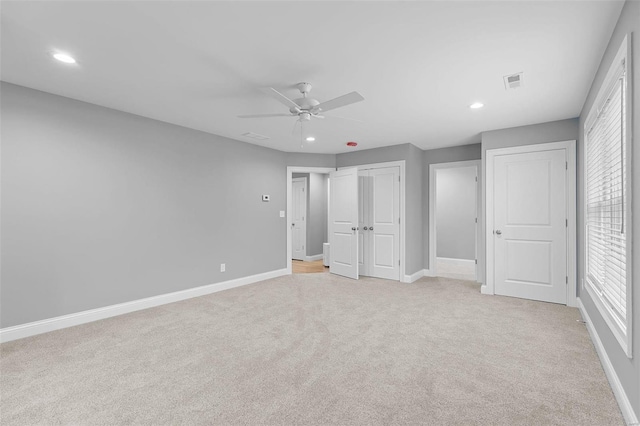 unfurnished bedroom featuring ceiling fan and light carpet