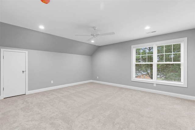 bonus room featuring ceiling fan, light carpet, and vaulted ceiling