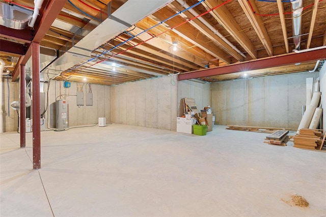 basement featuring electric panel and water heater