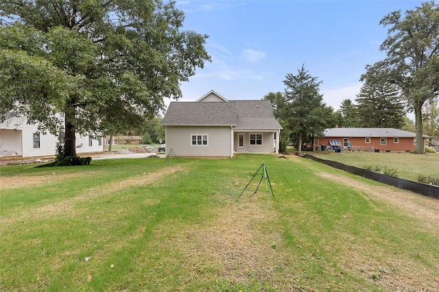 rear view of house with a yard