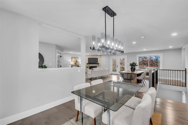 dining area with hardwood / wood-style flooring, french doors, and a chandelier