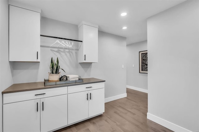 kitchen with white cabinets and light wood-type flooring