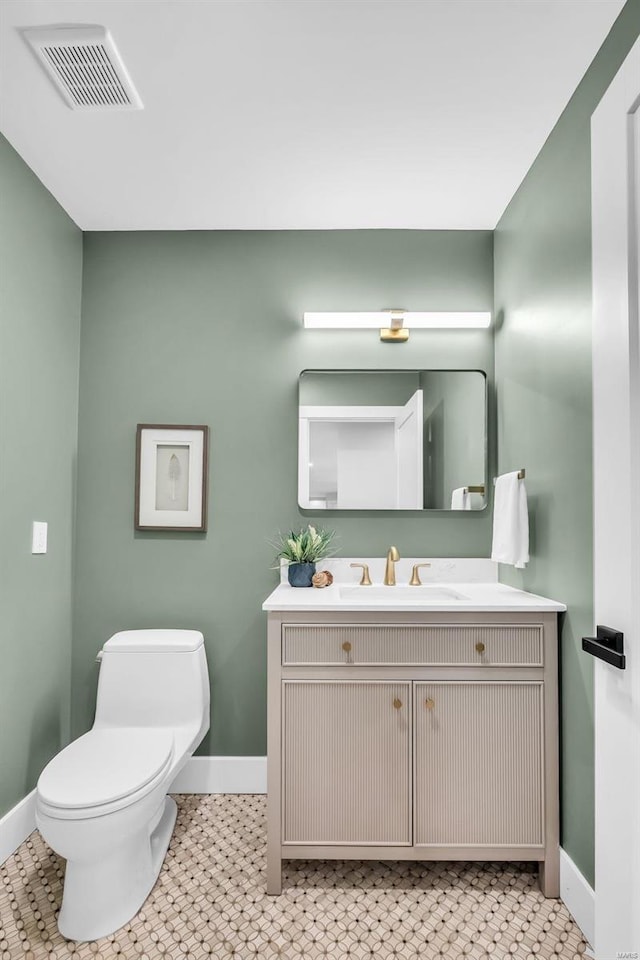 bathroom featuring tile patterned floors, vanity, and toilet