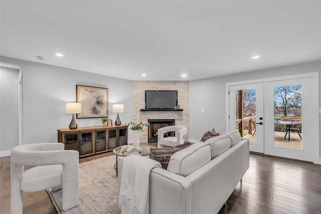 living room featuring a fireplace, french doors, and hardwood / wood-style flooring