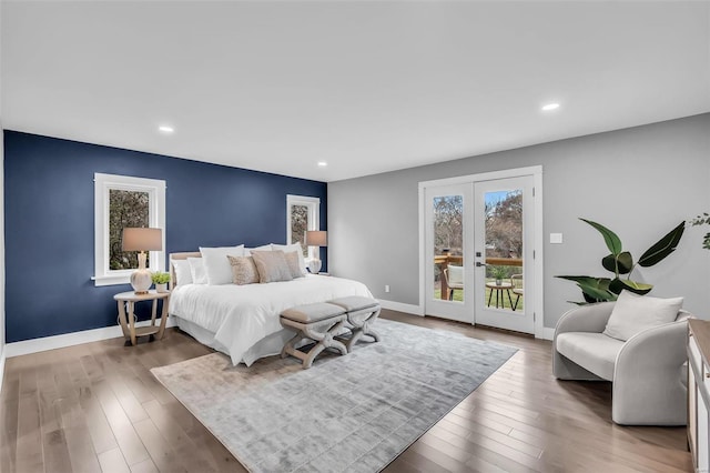 bedroom featuring french doors, access to outside, and dark hardwood / wood-style floors