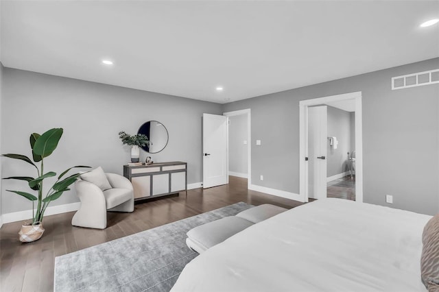 bedroom with dark hardwood / wood-style flooring