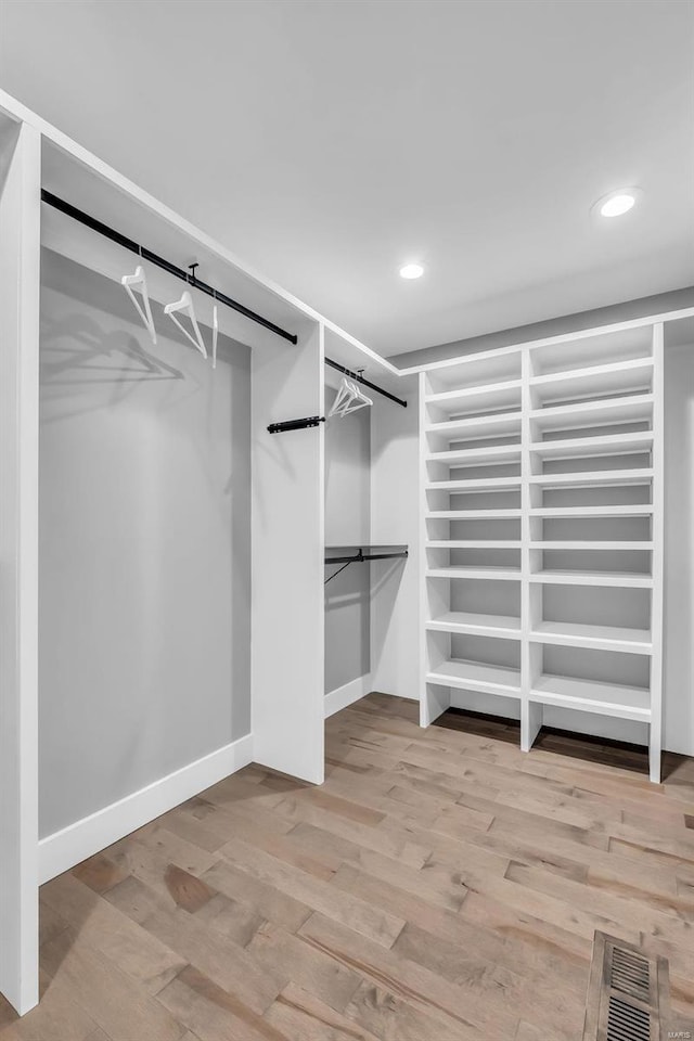 walk in closet featuring light hardwood / wood-style flooring