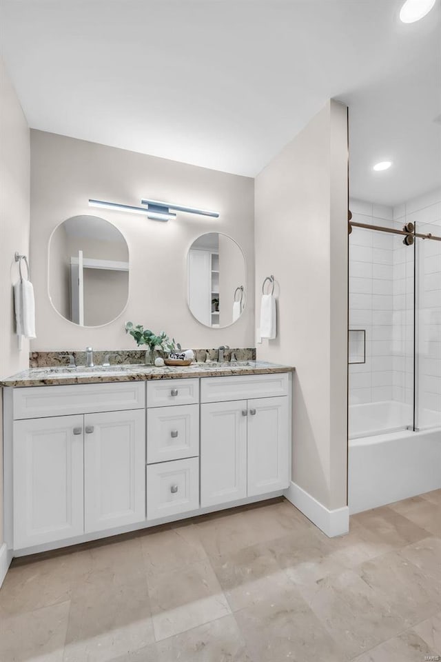 bathroom featuring vanity and combined bath / shower with glass door