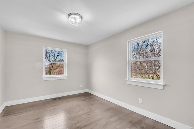 unfurnished room featuring hardwood / wood-style floors