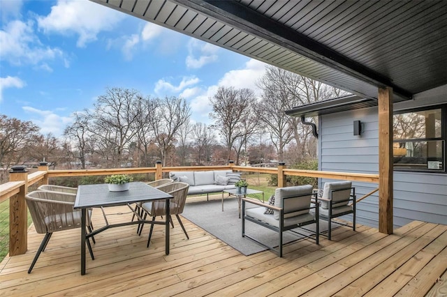 wooden terrace with an outdoor hangout area