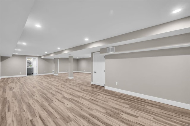 basement with light hardwood / wood-style flooring