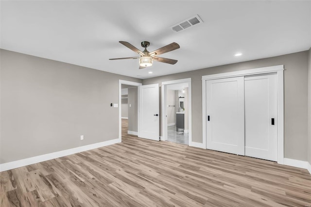 unfurnished bedroom with a closet, ceiling fan, and light hardwood / wood-style flooring