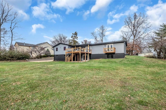 rear view of house with a lawn and a wooden deck