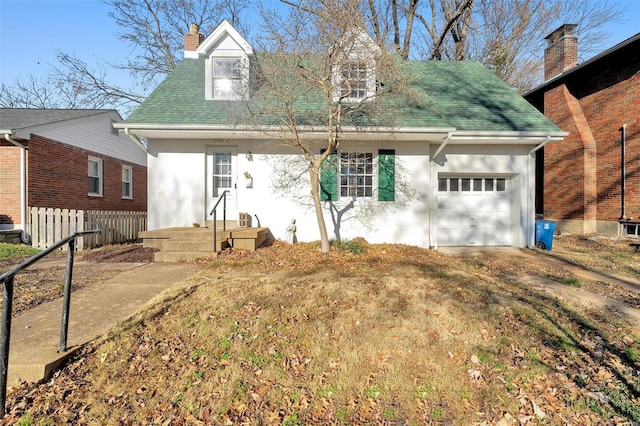 new england style home featuring a garage