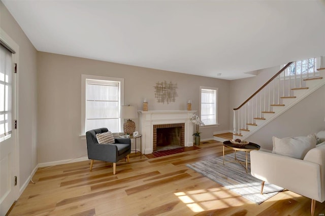 living room with a fireplace and light wood-type flooring