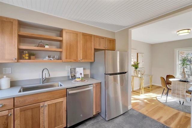 kitchen featuring sink, light hardwood / wood-style floors, and appliances with stainless steel finishes