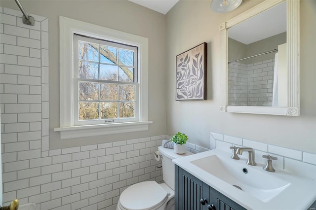 bathroom with vanity, toilet, tile walls, and curtained shower