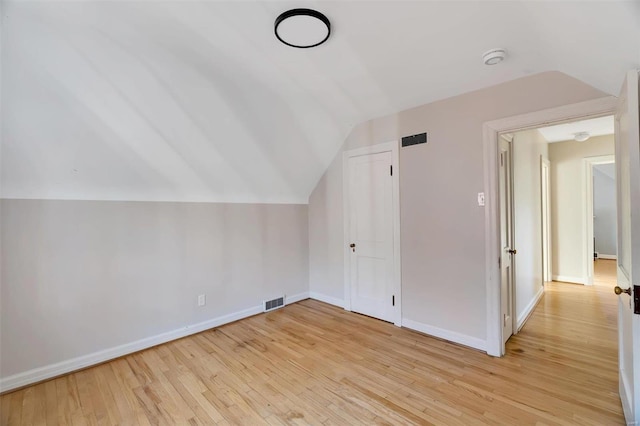 bonus room featuring light wood-type flooring and lofted ceiling