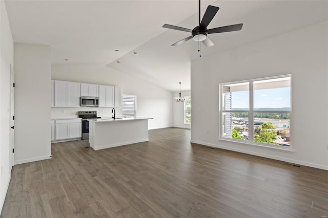 kitchen with white cabinetry, hardwood / wood-style floors, an island with sink, vaulted ceiling, and appliances with stainless steel finishes