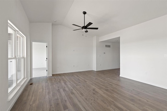 empty room with ceiling fan, wood-type flooring, and lofted ceiling