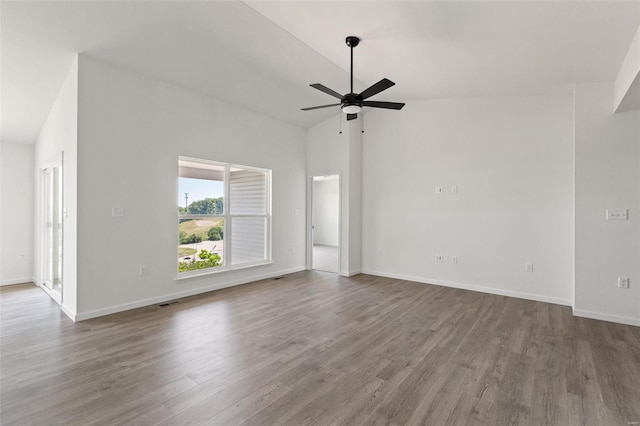 unfurnished living room with hardwood / wood-style floors, high vaulted ceiling, and ceiling fan