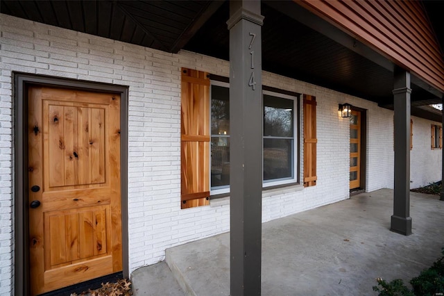 view of exterior entry with a porch