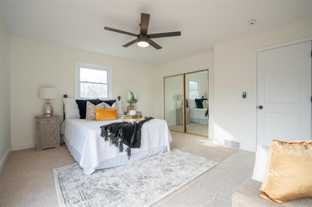 bedroom with light carpet, a closet, and ceiling fan