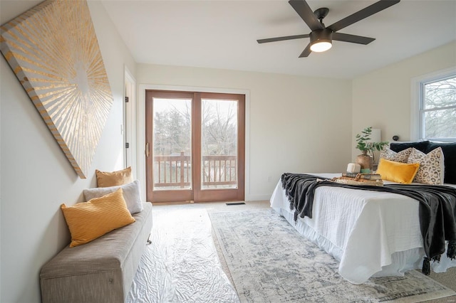 carpeted bedroom featuring ceiling fan and access to exterior