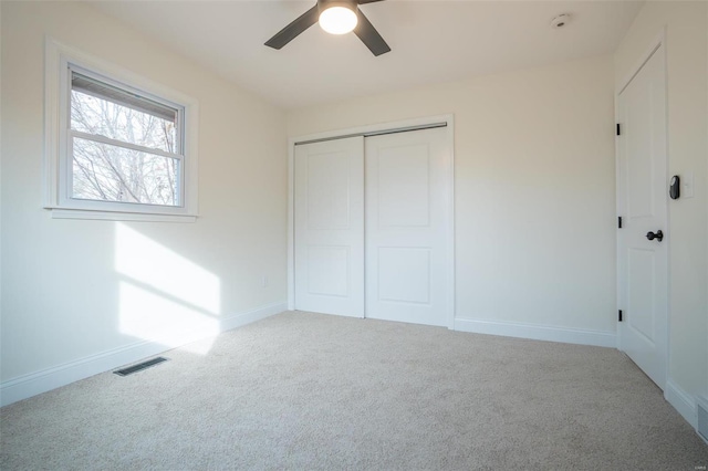 unfurnished bedroom with a closet, ceiling fan, and carpet