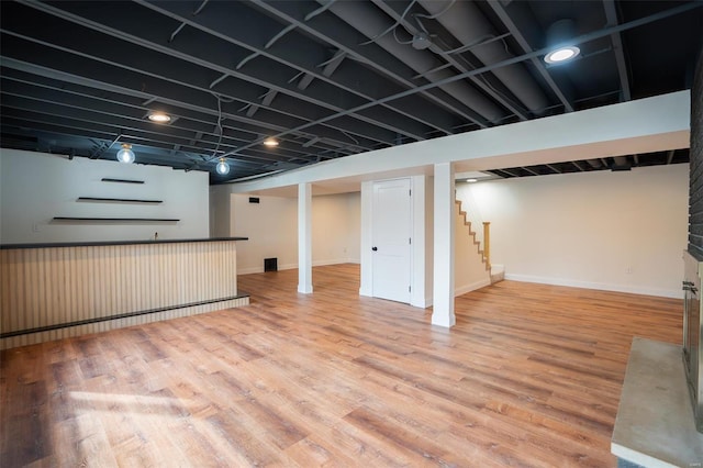 basement with hardwood / wood-style flooring