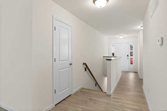 corridor with light hardwood / wood-style flooring