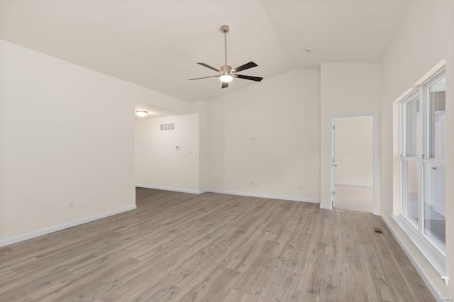 unfurnished room featuring ceiling fan, plenty of natural light, lofted ceiling, and light hardwood / wood-style flooring