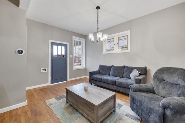 living room featuring a chandelier and light hardwood / wood-style flooring