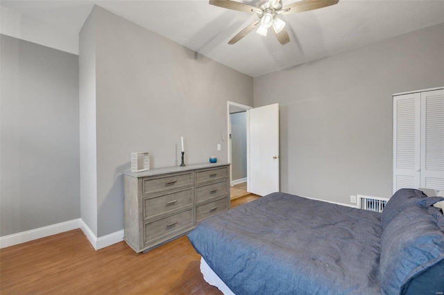 bedroom with ceiling fan, a closet, and light hardwood / wood-style flooring