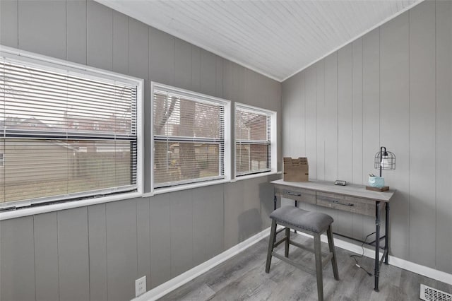 office with plenty of natural light, ornamental molding, and light wood-type flooring