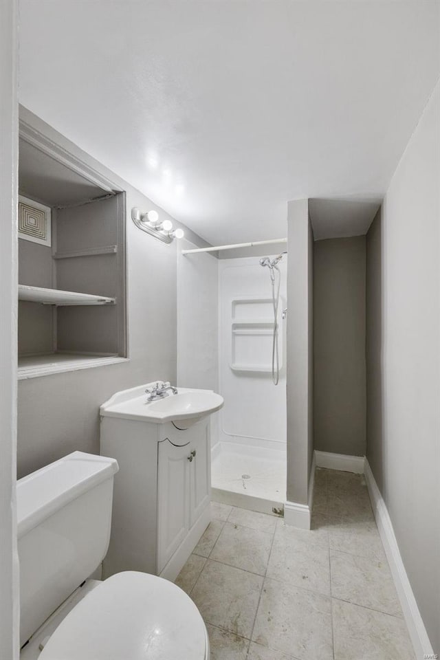 bathroom featuring a shower, vanity, and toilet