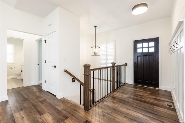 entryway featuring a chandelier and dark hardwood / wood-style floors