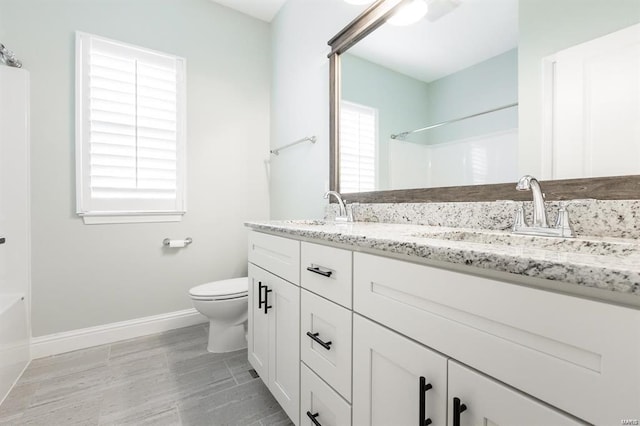 bathroom featuring hardwood / wood-style flooring, vanity, and toilet